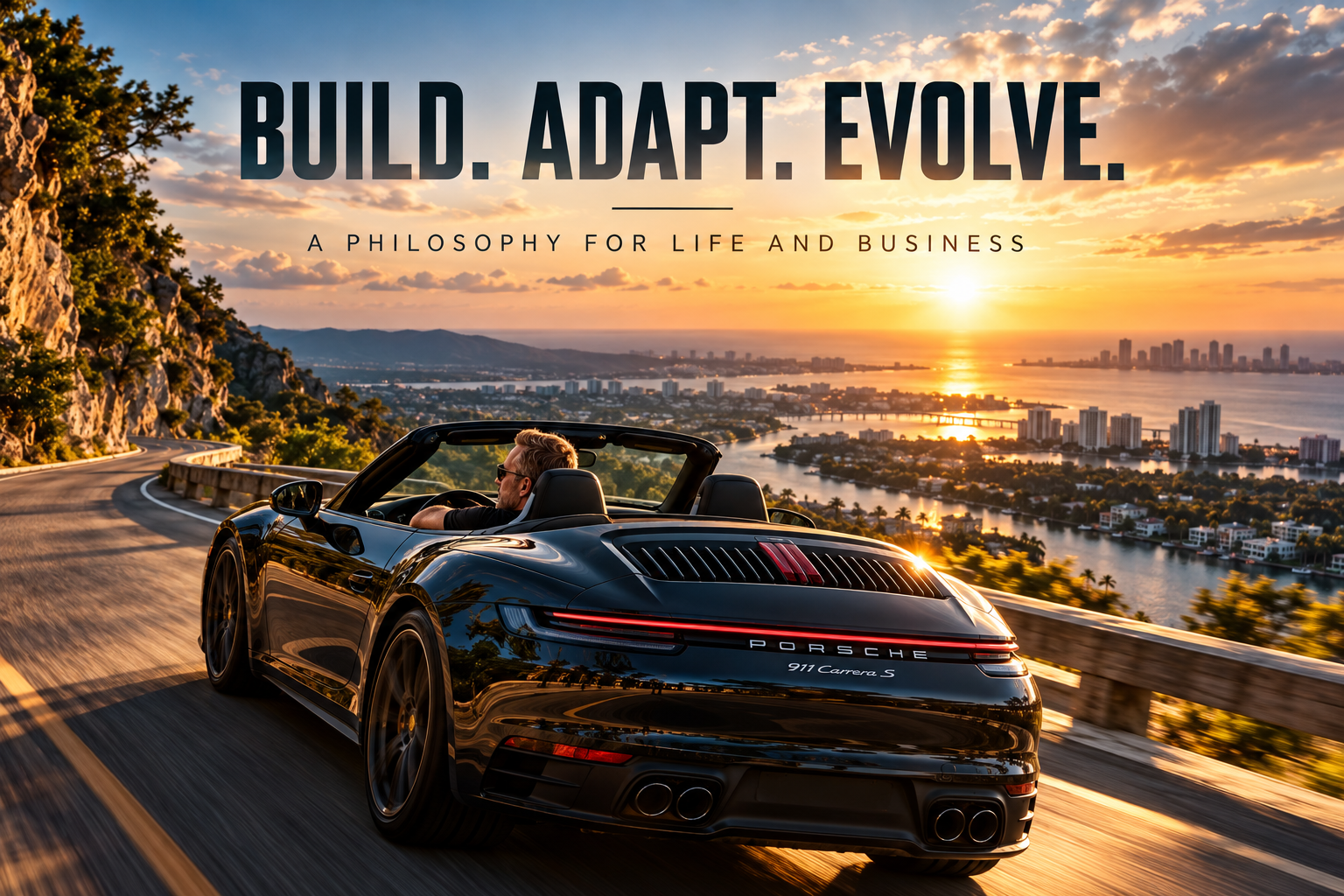Black Porsche convertible on a scenic coastal mountain road at sunset, with the headline BUILD. ADAPT. EVOLVE. above the coastline.